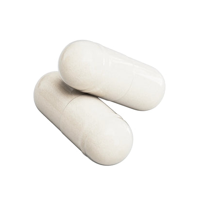 Two white vegetable capsules of IKOLLIN Nitric Oxide supplement