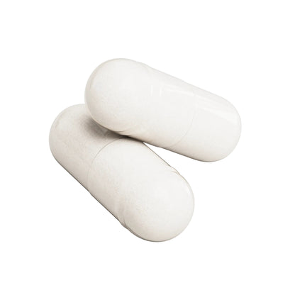 Two white IKOLLIN Magnesium Glycinate vegetable capsules crossed over each other, close-up, white background
